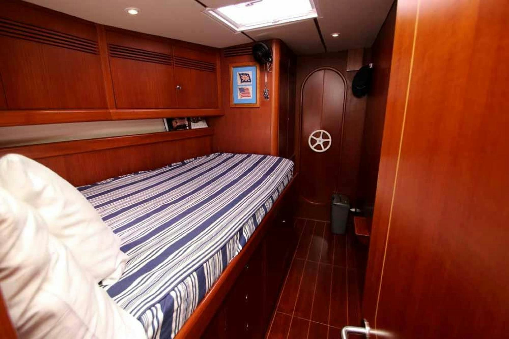 a room with a bed and a mirror aboard MAYA RAY Yacht for Sale
