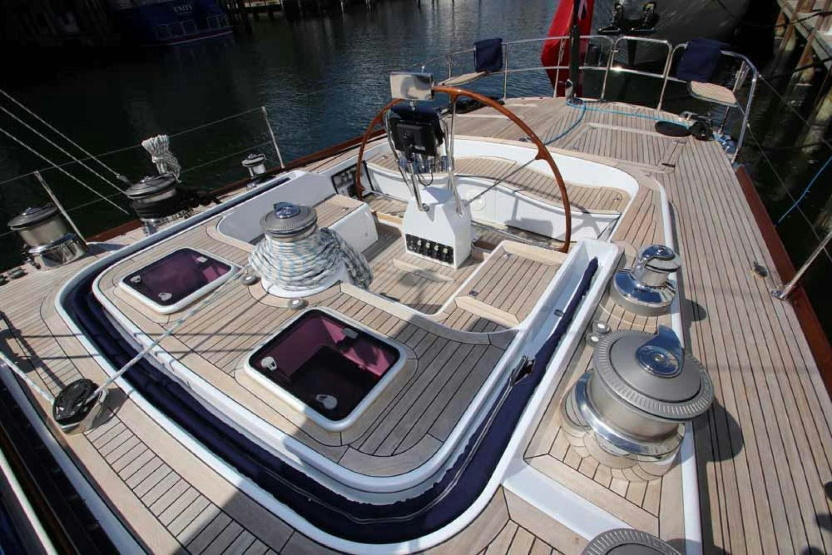 a deck with a boat and a deck with a deck and a view of the water aboard MAYA RAY Yacht for Sale