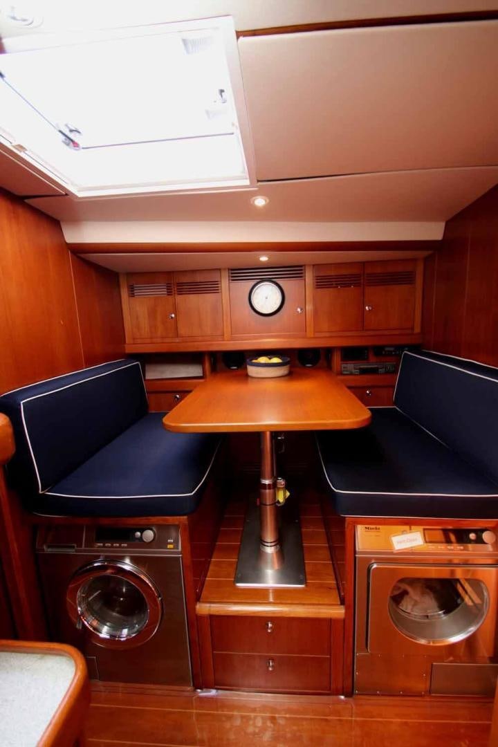 a room with a table and chairs aboard MAYA RAY Yacht for Sale