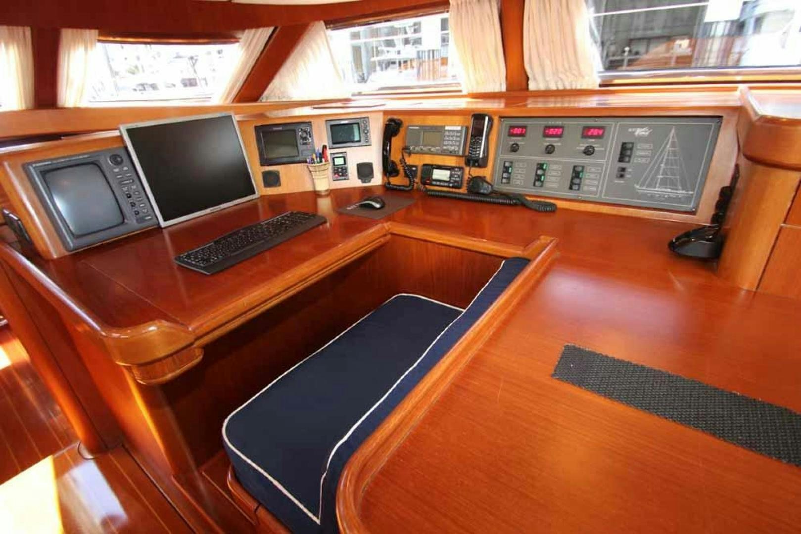 a desk with computers and other electronic devices on it aboard MAYA RAY Yacht for Sale