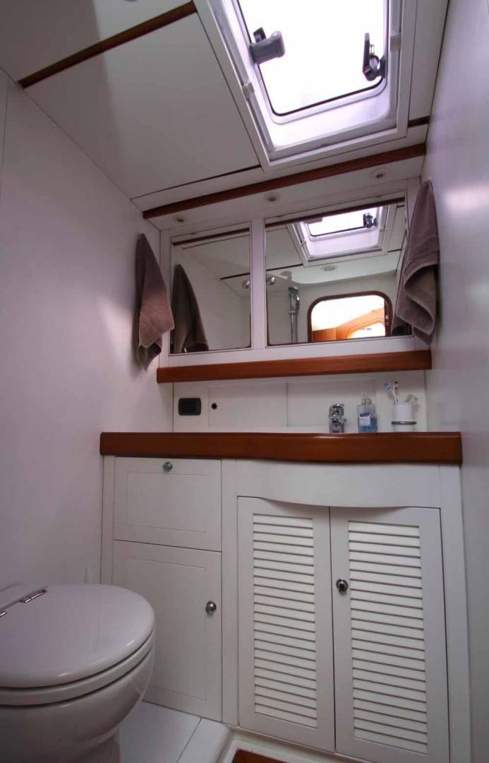 a small bathroom with a small shelf aboard MAYA RAY Yacht for Sale