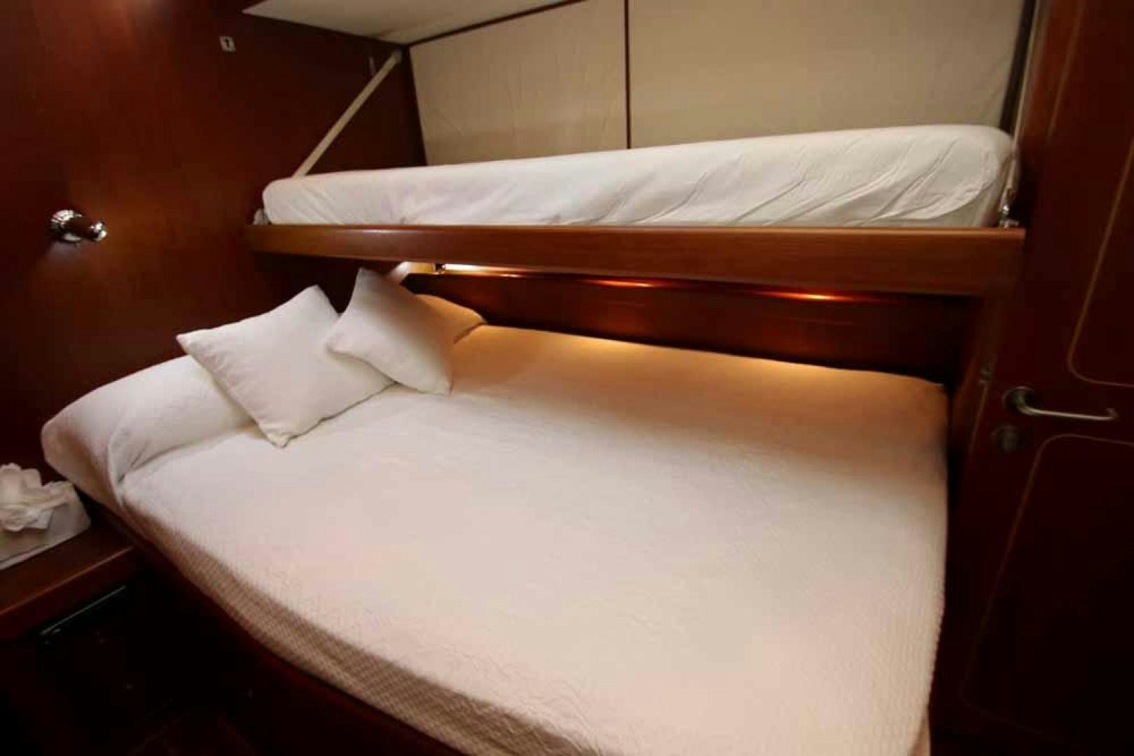 a bed with white sheets aboard MAYA RAY Yacht for Sale
