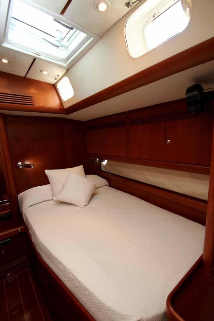 a bed with white sheets aboard MAYA RAY Yacht for Sale