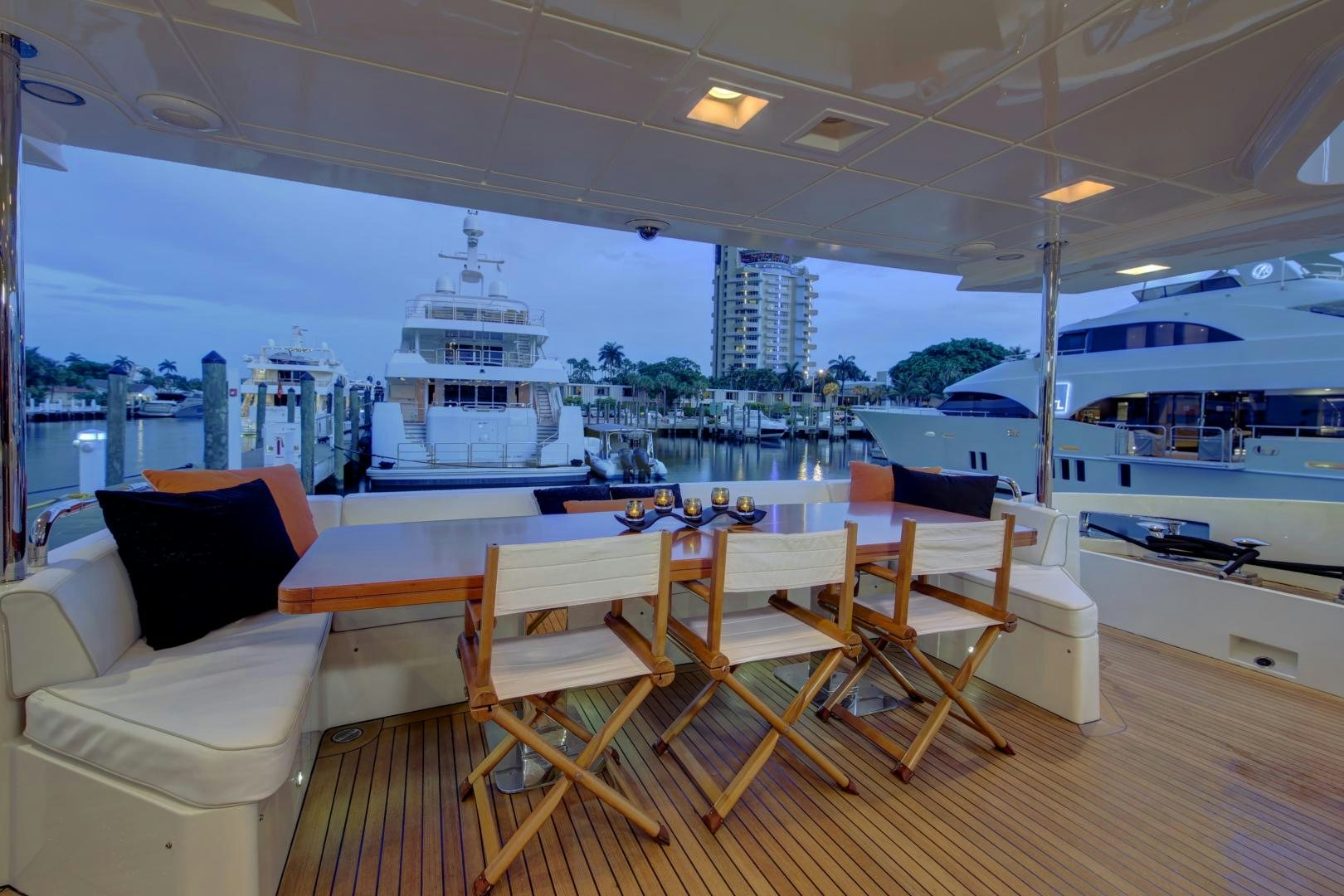 a room with a table chairs and a view of a city aboard SORRIDENTE Yacht for Sale