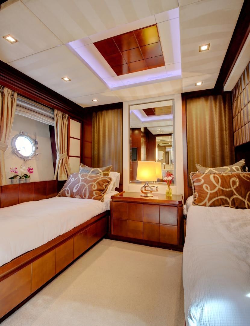 a bedroom with a bed and a mirror aboard SORRIDENTE Yacht for Sale