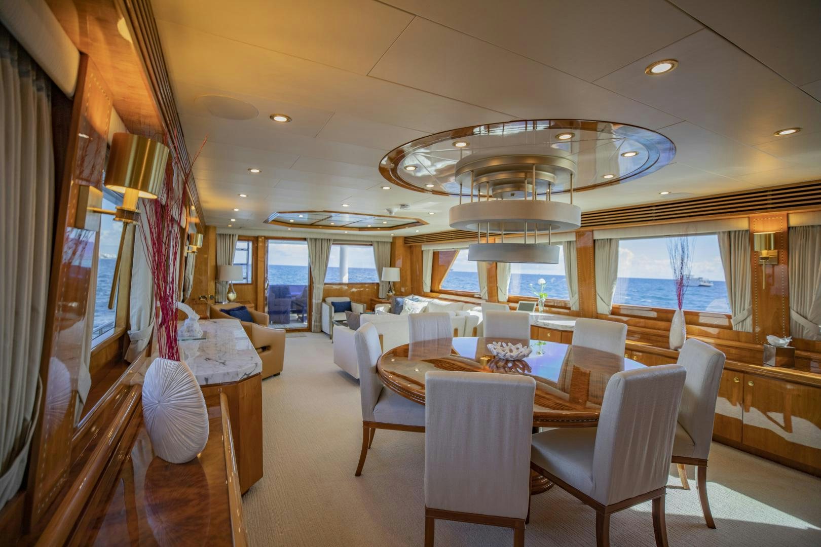 a room with tables and chairs aboard FLY BOYS Yacht for Sale