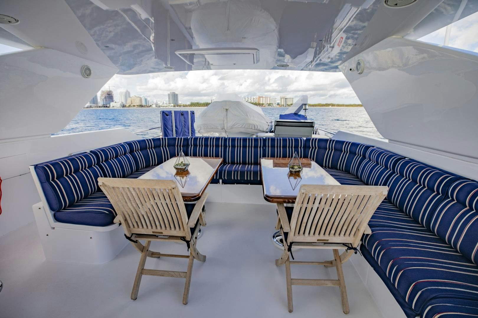 a room with a table and chairs aboard FLY BOYS Yacht for Sale