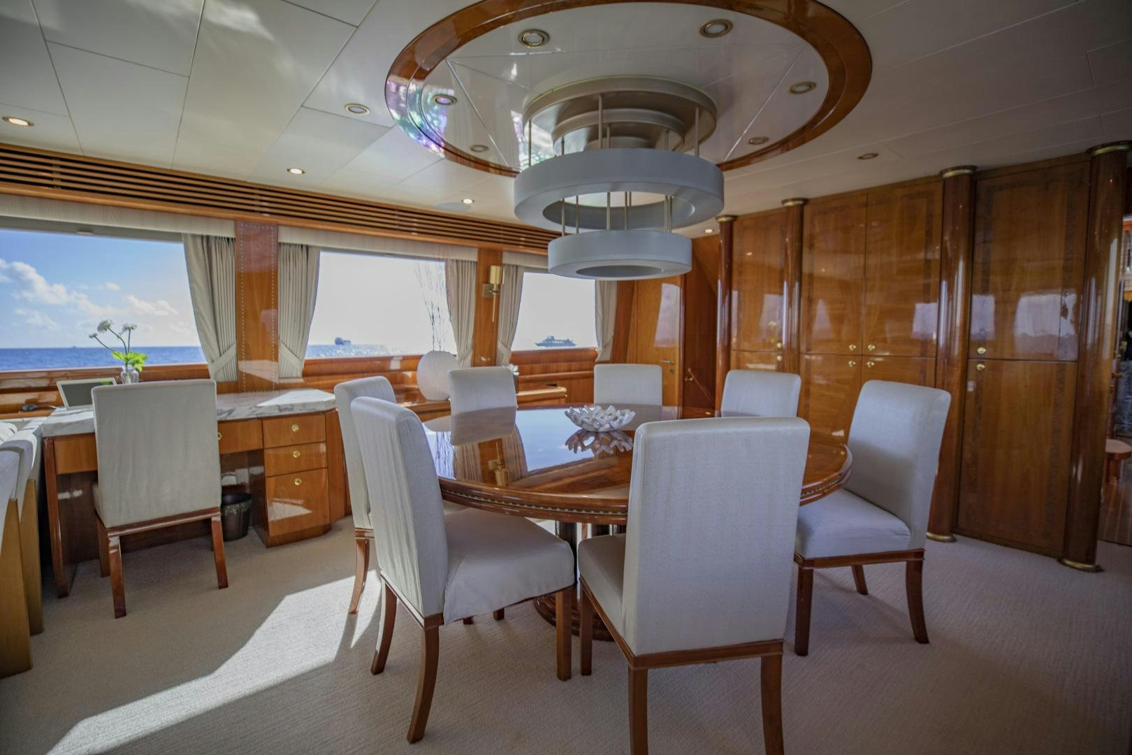 a large room with a table and chairs aboard FLY BOYS Yacht for Sale