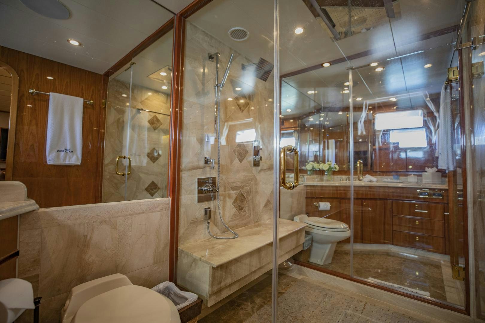 a bathroom with a glass shower aboard FLY BOYS Yacht for Sale
