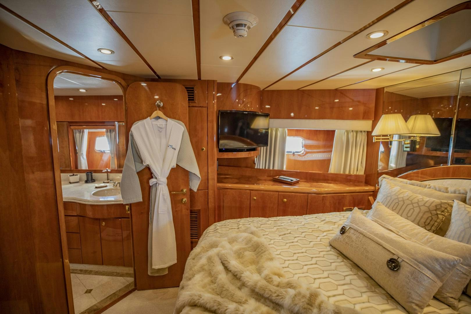 a robe on a bed aboard FLY BOYS Yacht for Sale