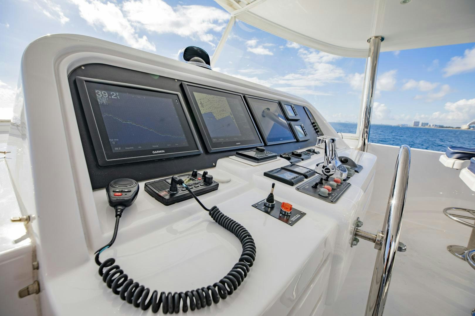 a white space ship with a screen and several monitors on it aboard FLY BOYS Yacht for Sale