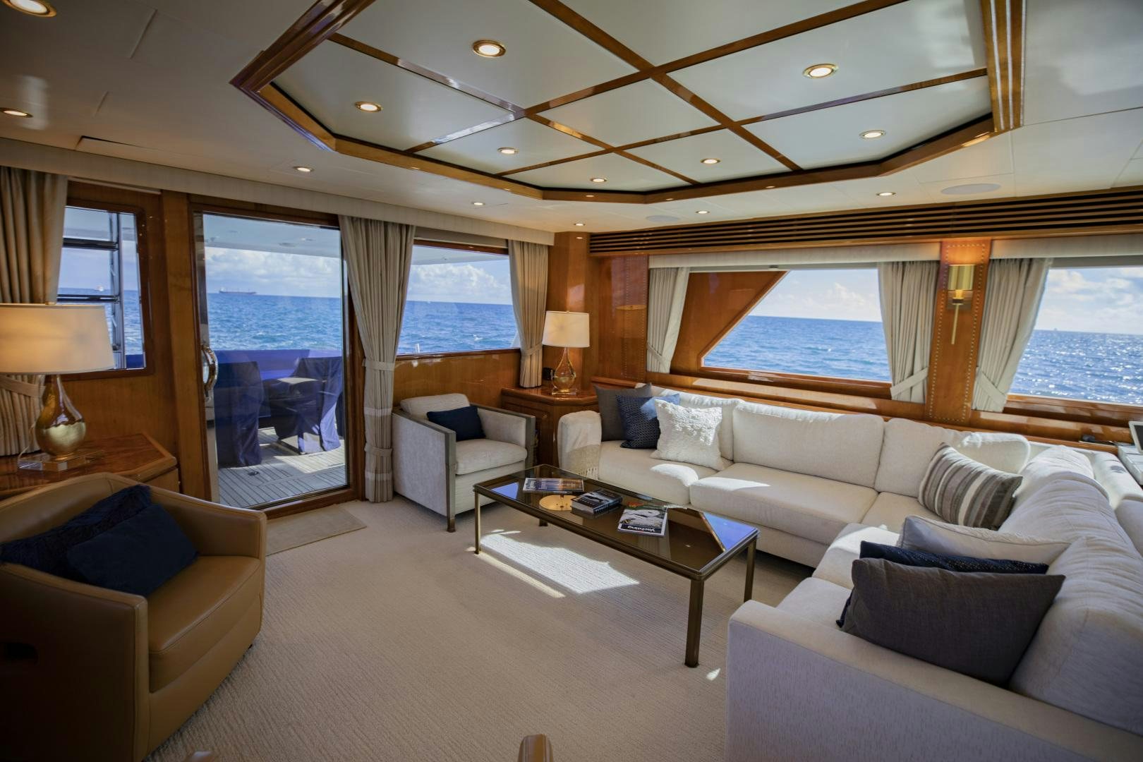 a living room with a large window aboard FLY BOYS Yacht for Sale
