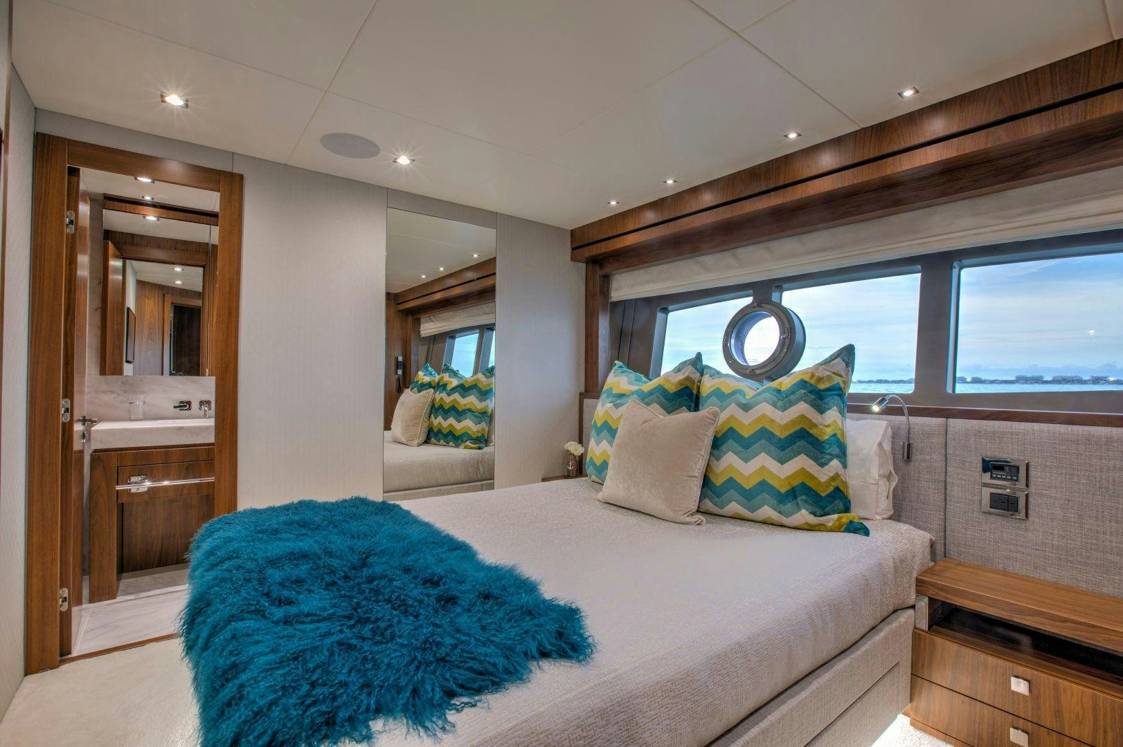 a bedroom with a bed and a mirror aboard PERSEVERANCE 3 Yacht for Sale