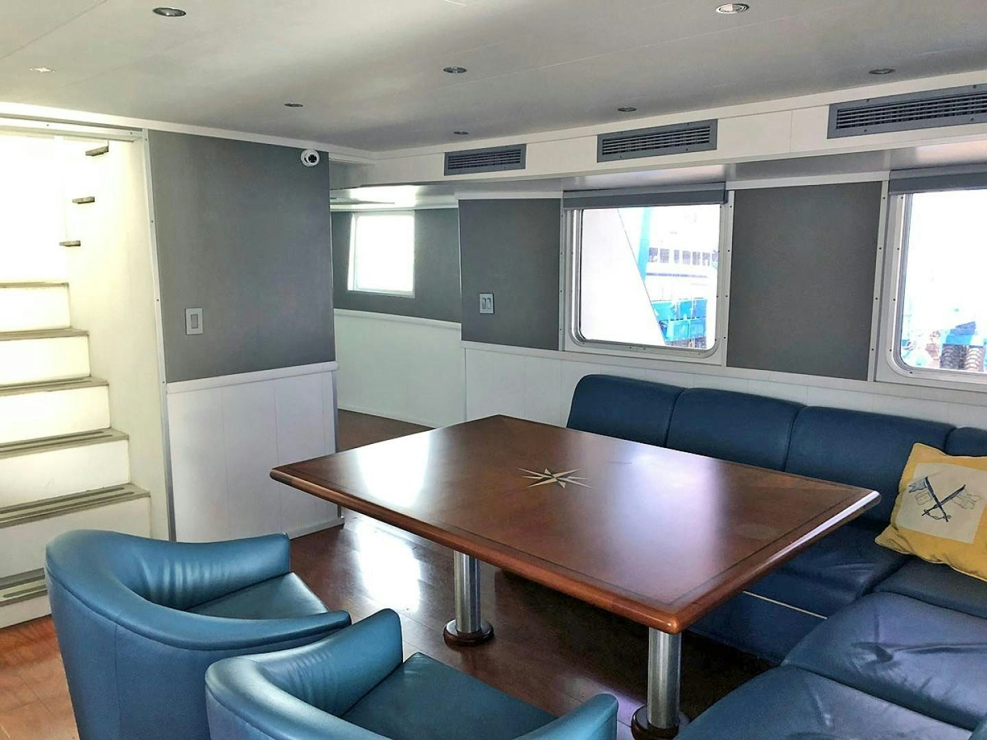 a table and chairs in a room aboard CARE BEAR Yacht for Sale