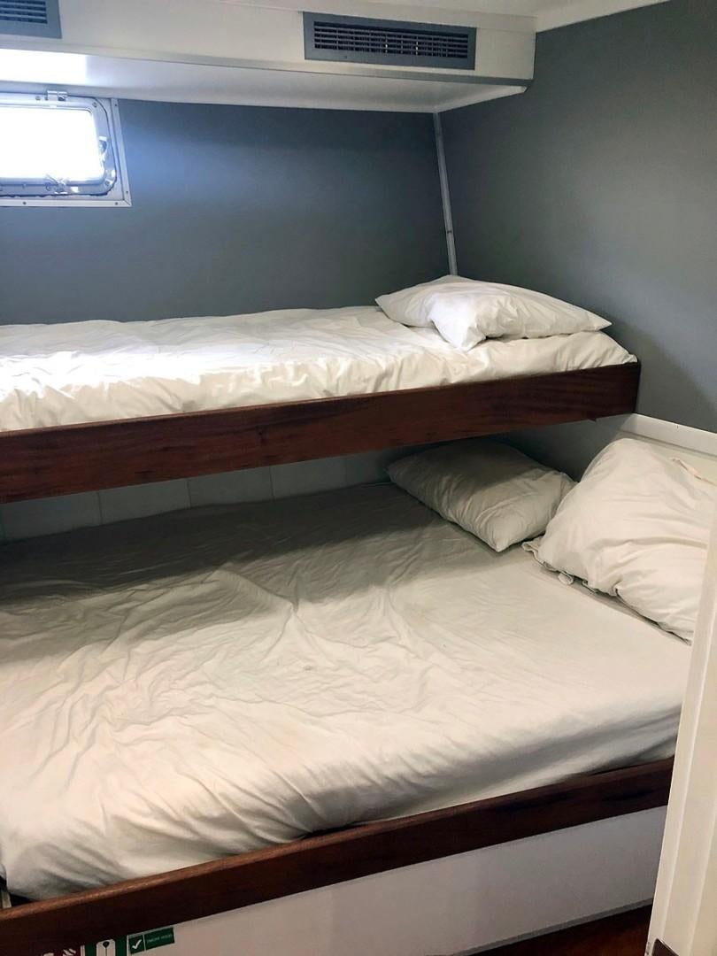a couple of beds in a room aboard CARE BEAR Yacht for Sale