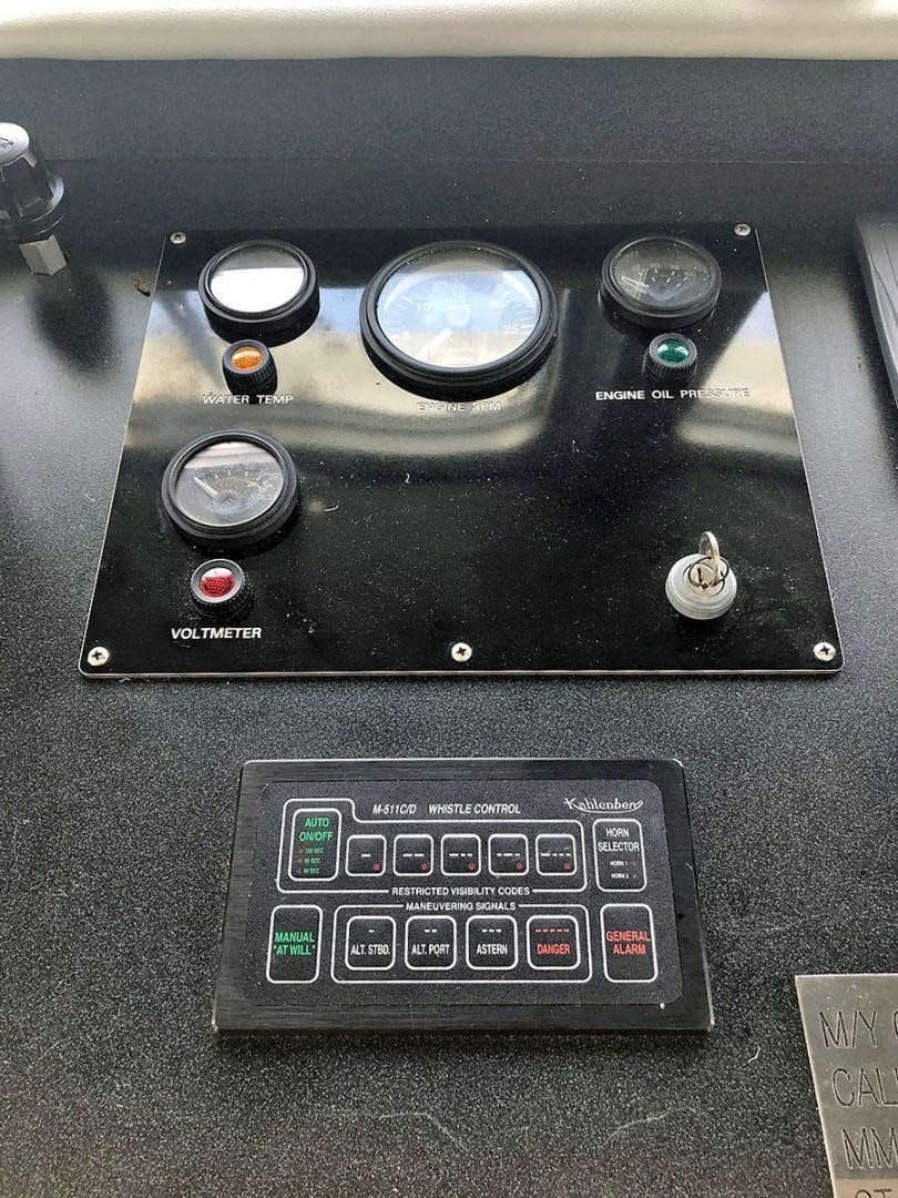 a black console with buttons and a screen aboard CARE BEAR Yacht for Sale