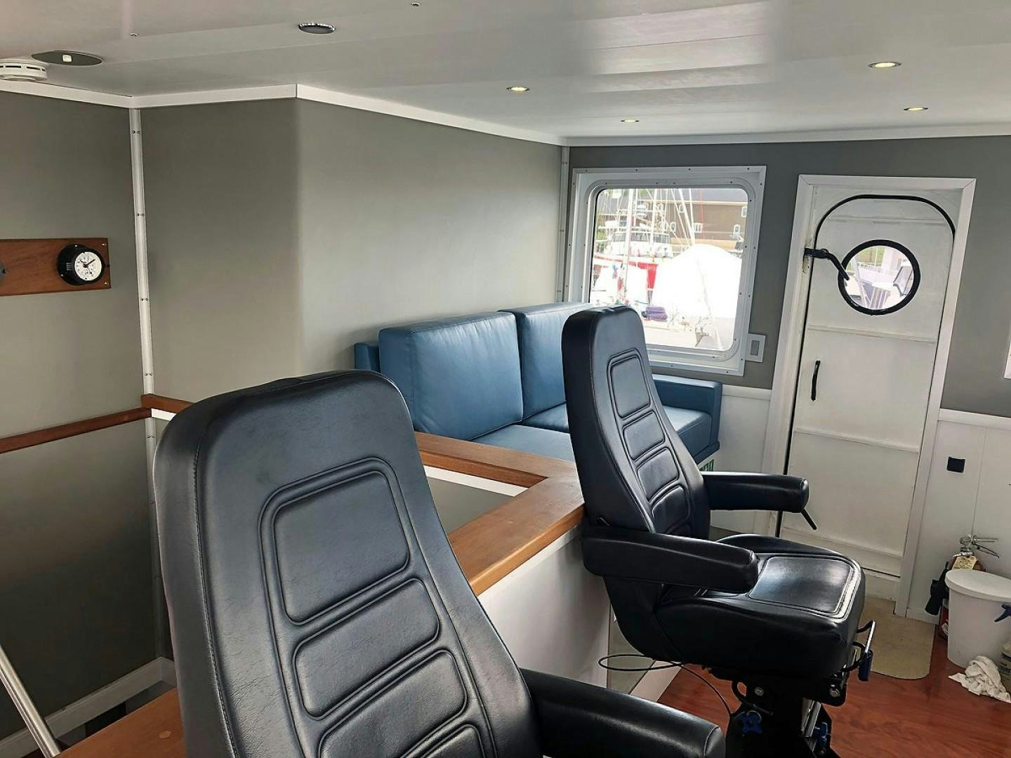 a room with a desk and chairs aboard CARE BEAR Yacht for Sale