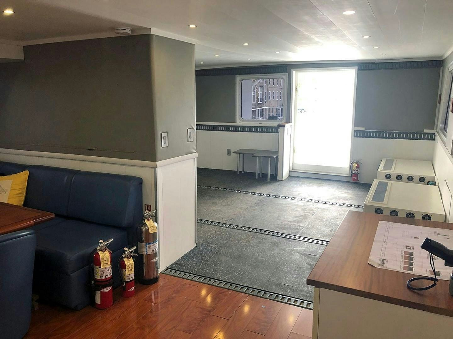 a living room with a couch and a table aboard CARE BEAR Yacht for Sale