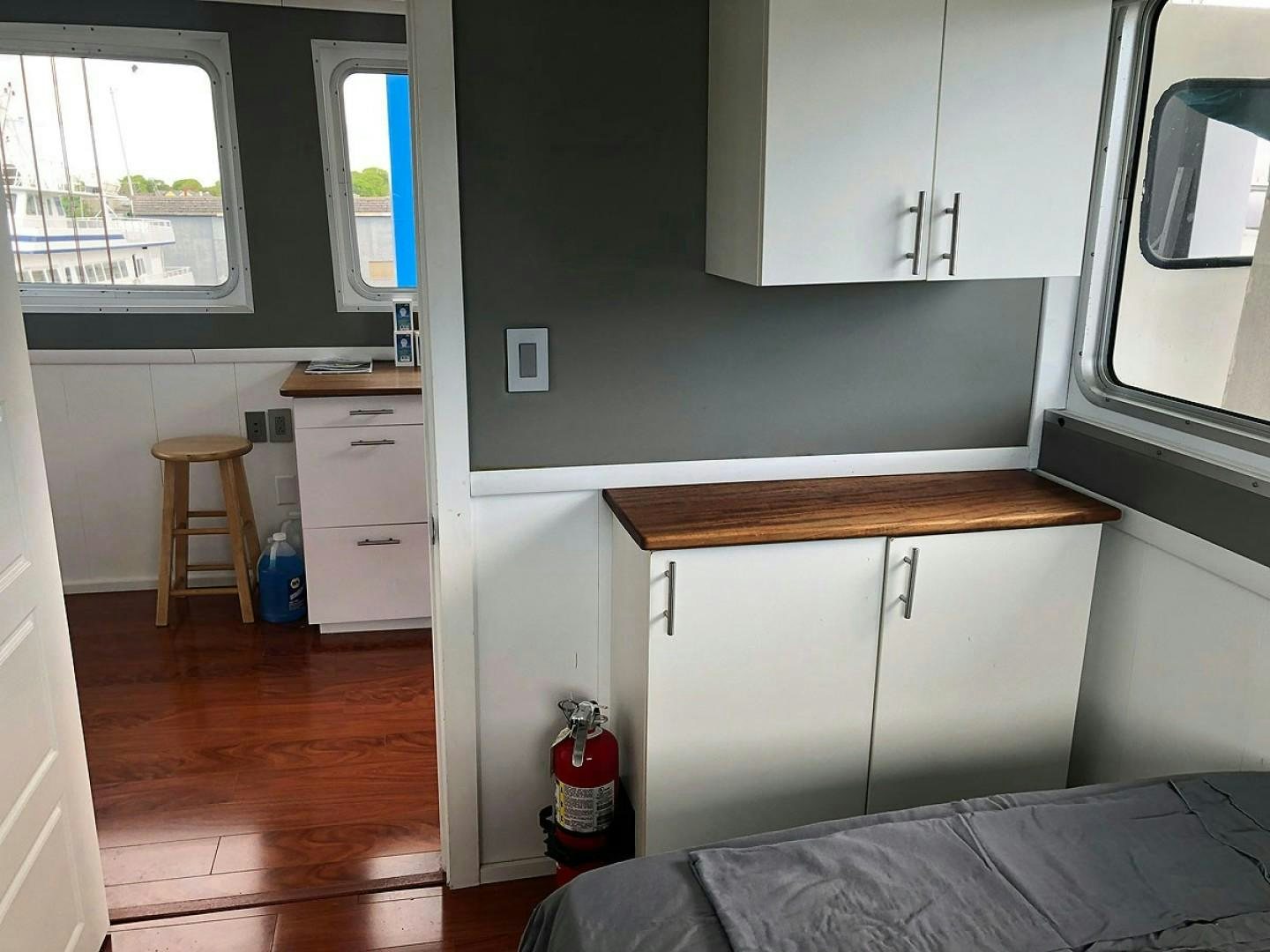 a small kitchen with a bed aboard CARE BEAR Yacht for Sale