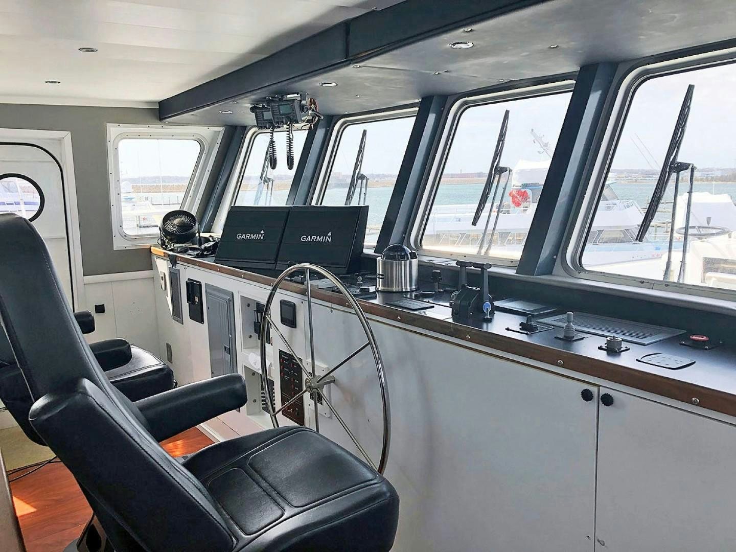 inside of a vehicle with a computer and a large window aboard CARE BEAR Yacht for Sale