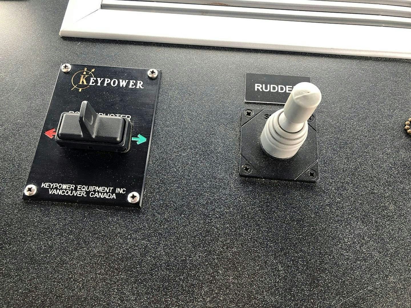 a group of black and silver electronic devices on a black surface aboard CARE BEAR Yacht for Sale