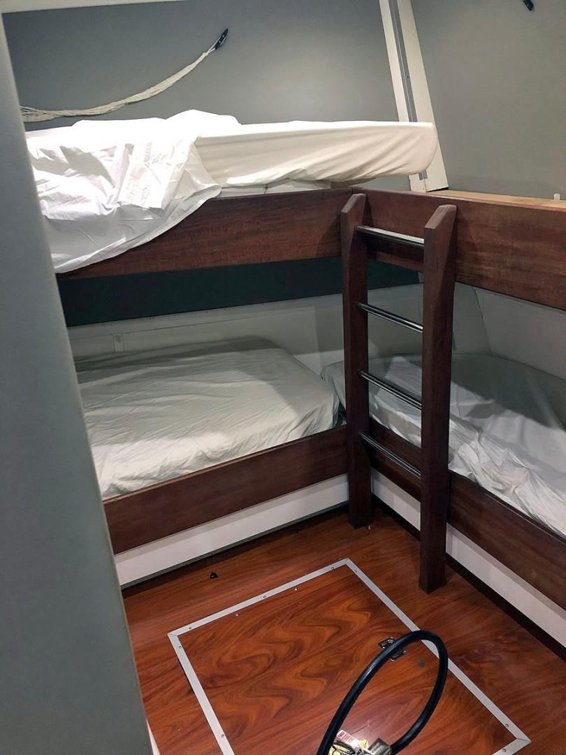 a bunk bed with a white sheet aboard CARE BEAR Yacht for Sale