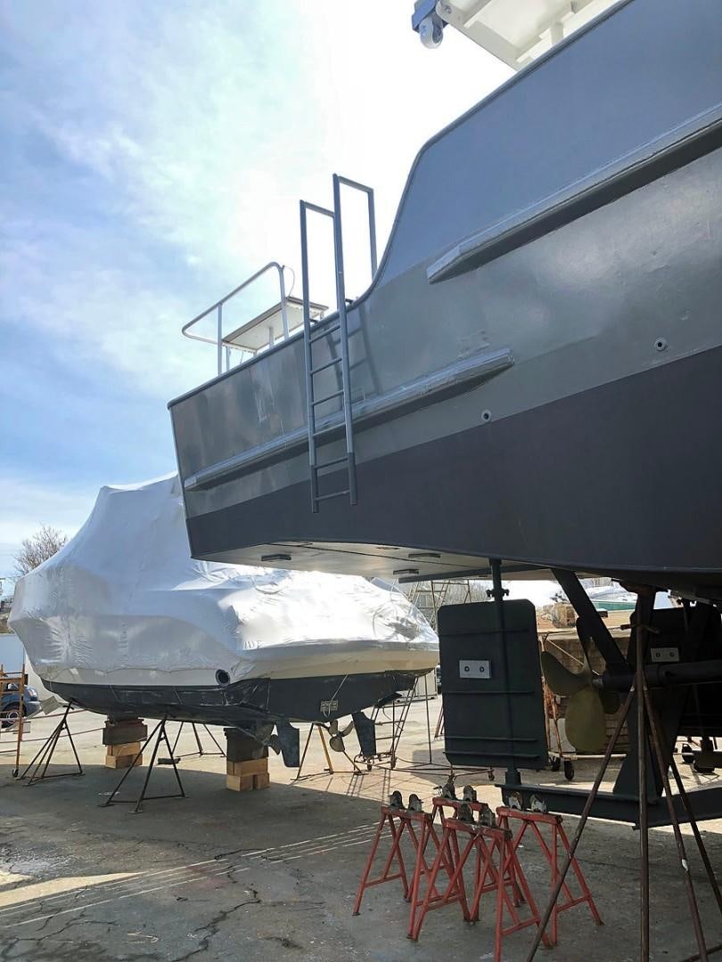 a large white boat on a dock aboard CARE BEAR Yacht for Sale