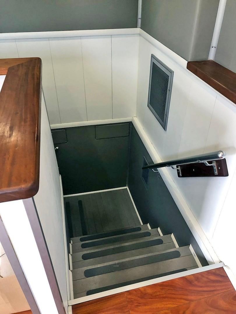 a staircase with a glass door aboard CARE BEAR Yacht for Sale