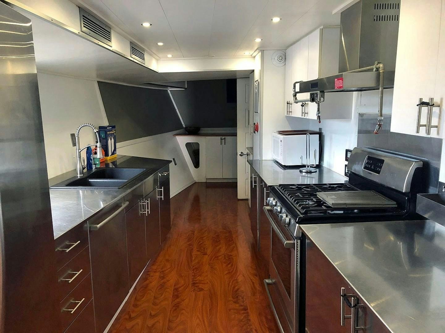 a kitchen with a wood floor aboard CARE BEAR Yacht for Sale