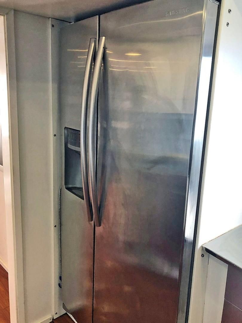 a silver refrigerator with a glass door aboard CARE BEAR Yacht for Sale