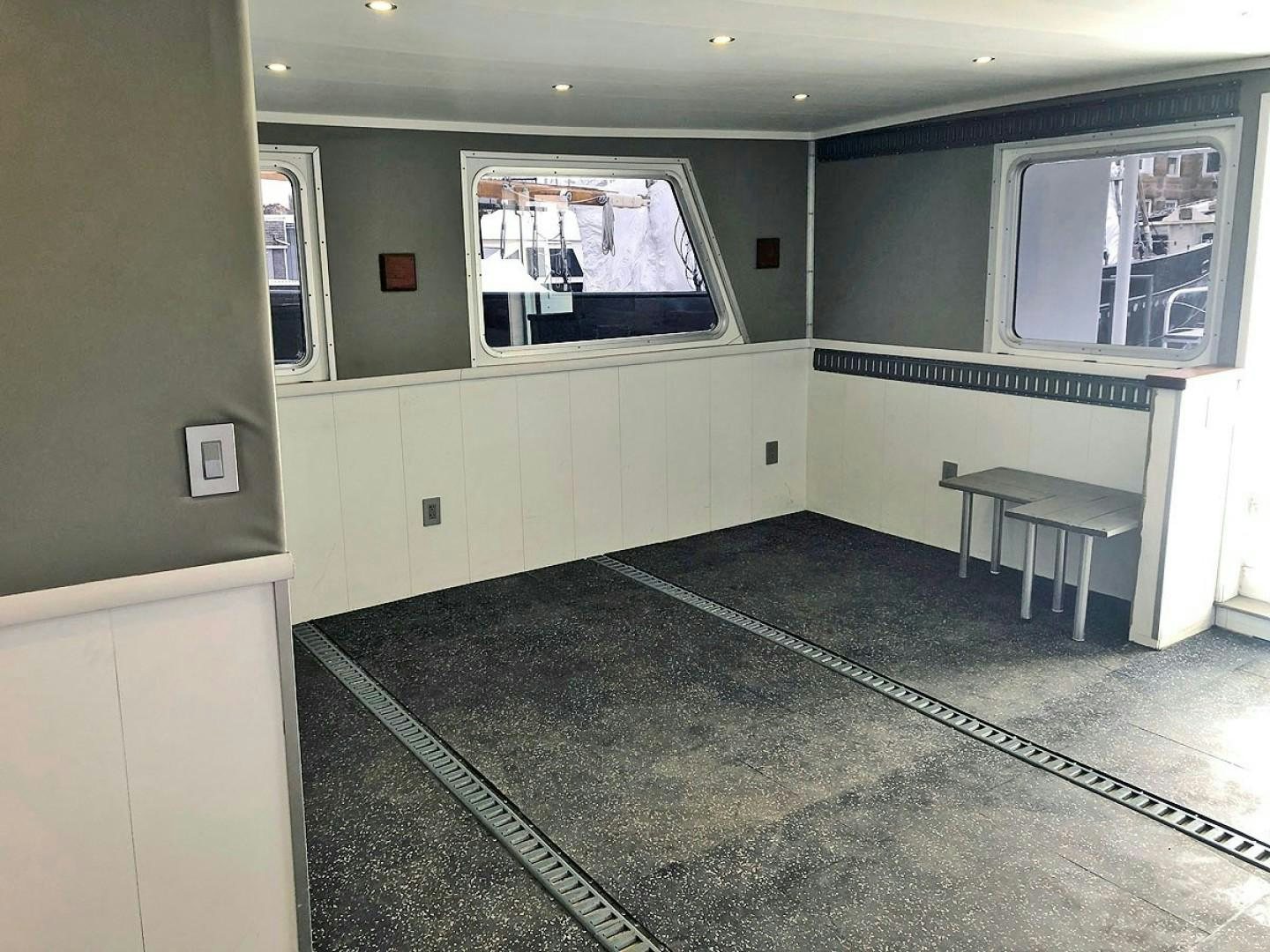 a room with a window and a table aboard CARE BEAR Yacht for Sale