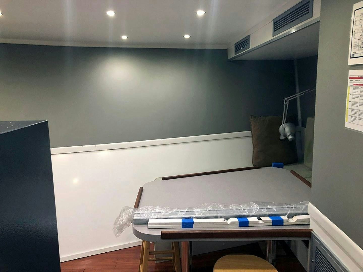 a room with a table and a computer aboard CARE BEAR Yacht for Sale