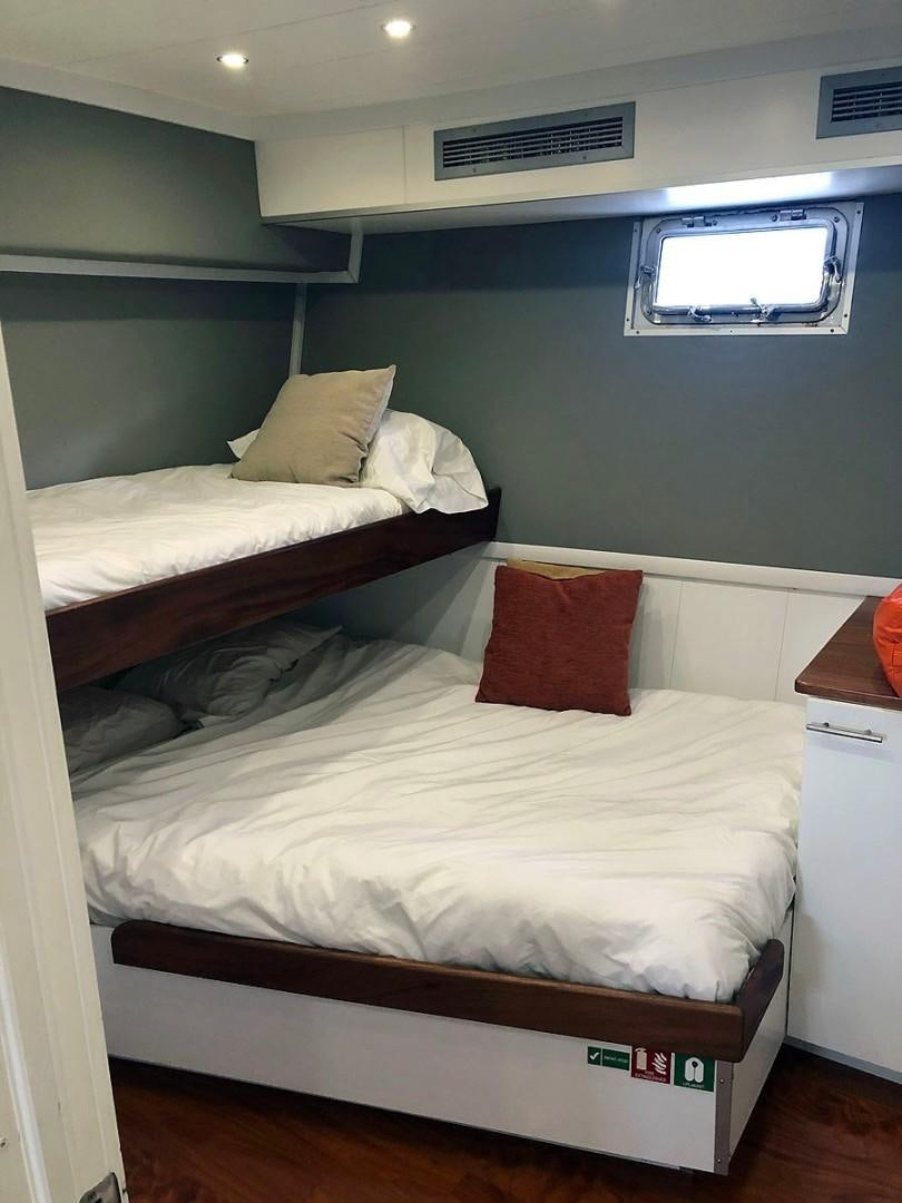 a couple of beds in a room aboard CARE BEAR Yacht for Sale