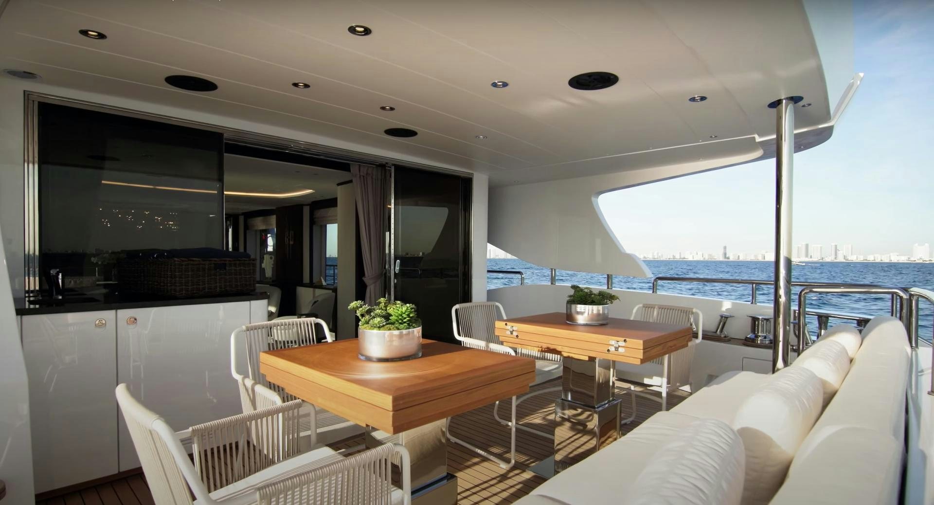 a room with a table and chairs aboard Benetti 95 Delfino Yacht for Sale