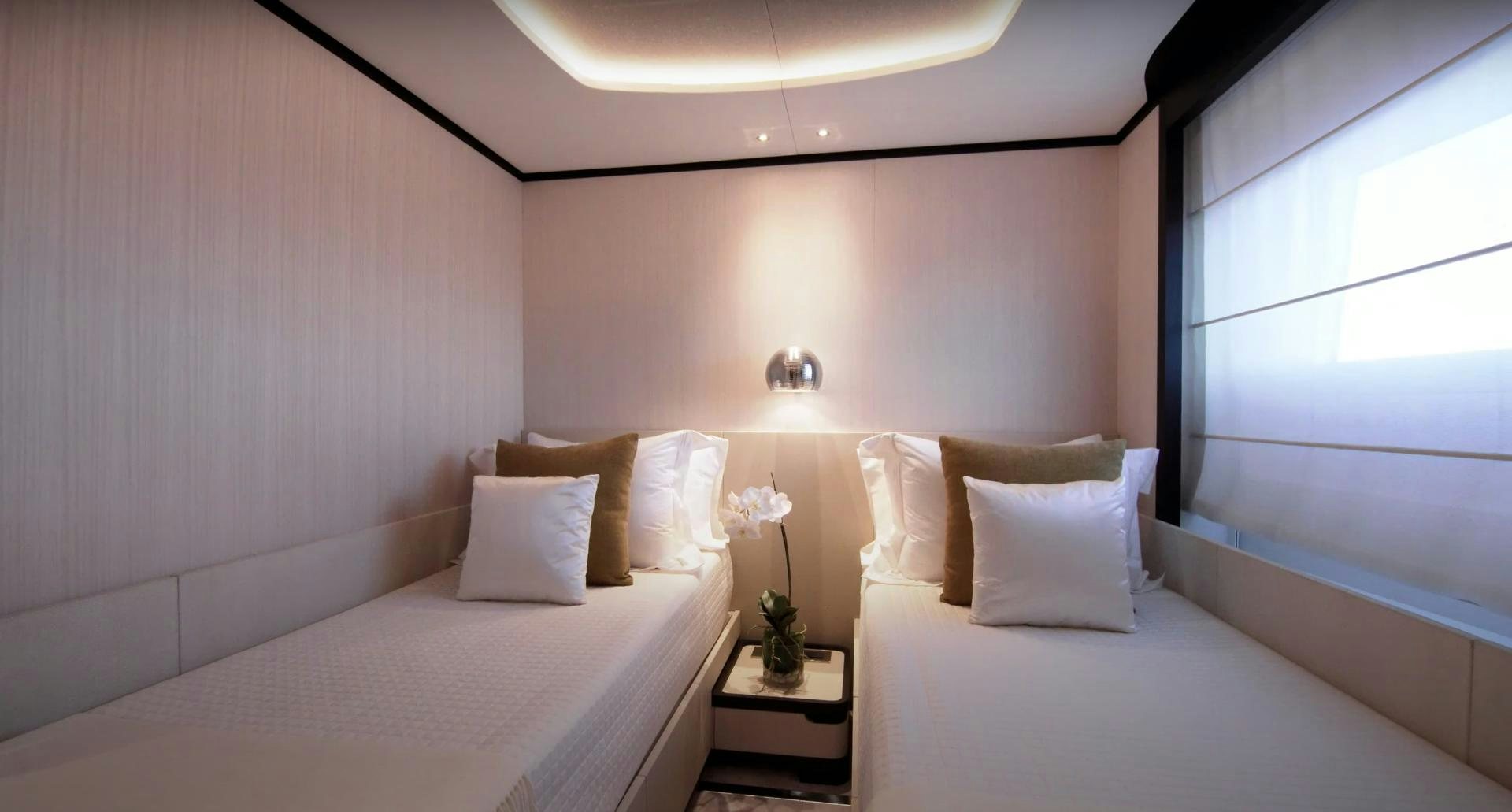 a room with two beds aboard Benetti 95 Delfino Yacht for Sale