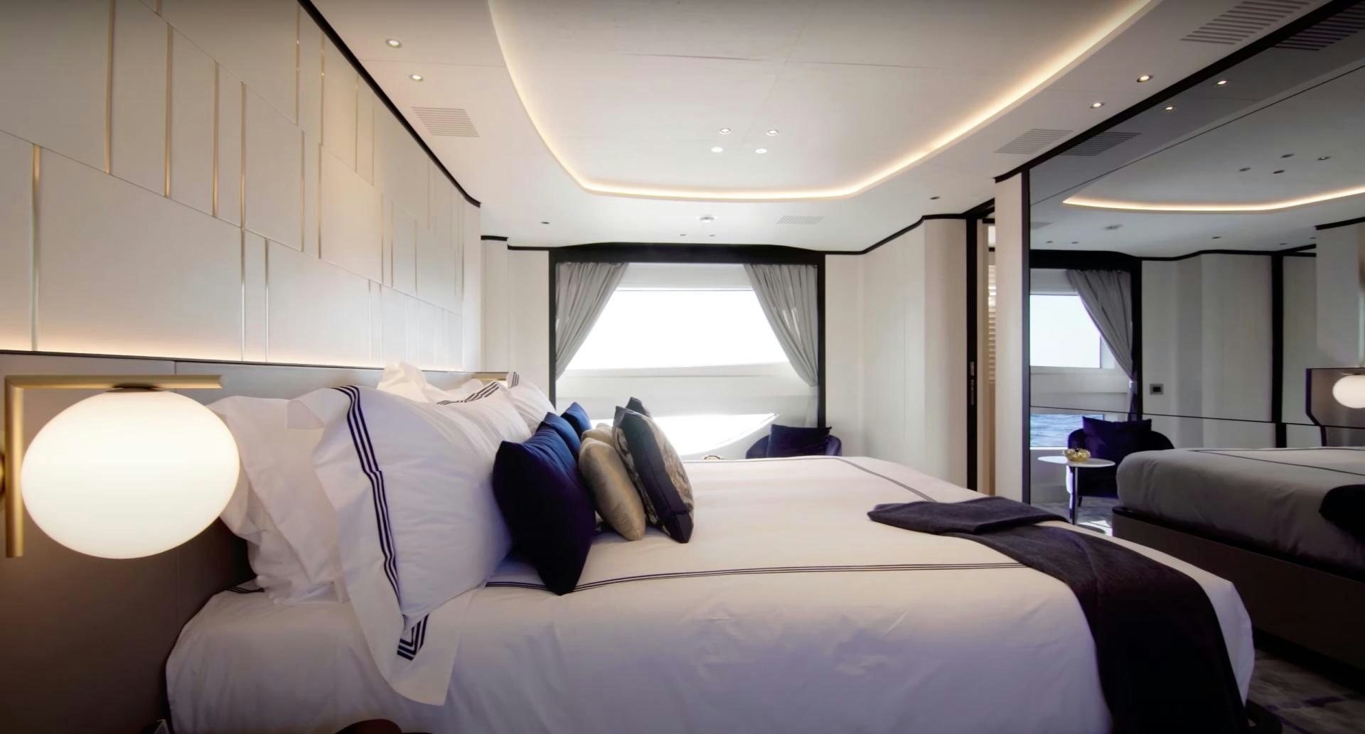 a bed with white sheets aboard Benetti 95 Delfino Yacht for Sale