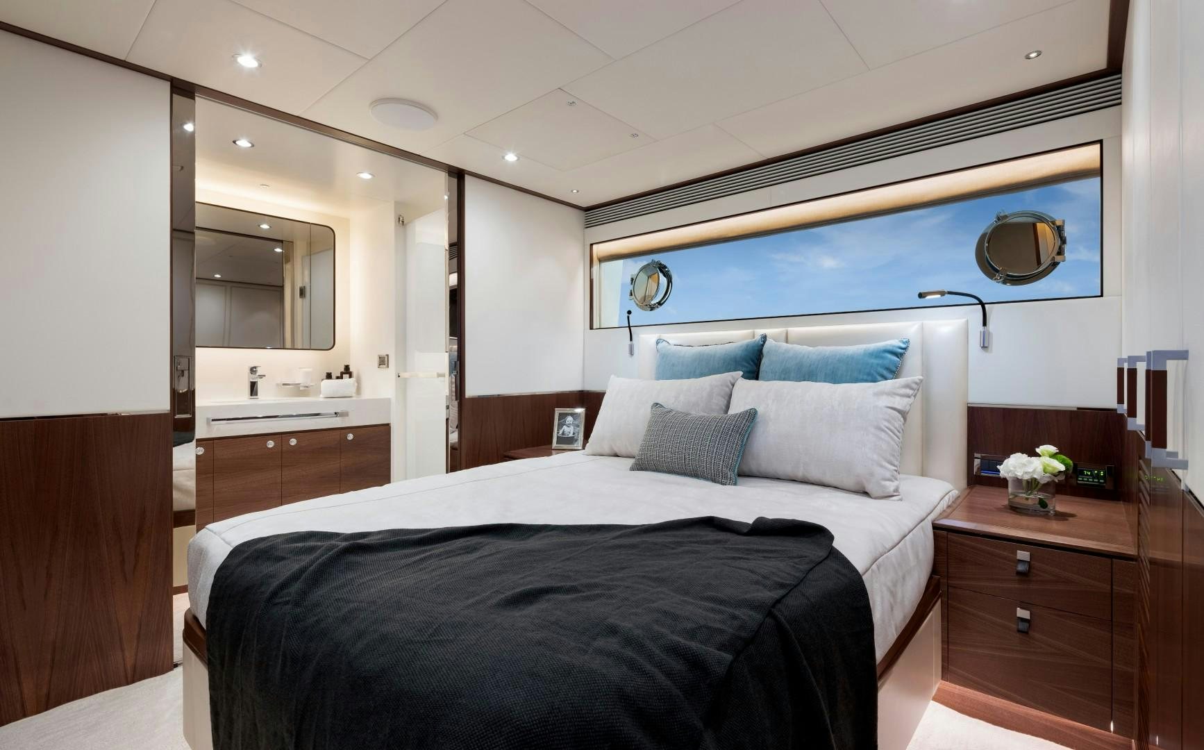 a bedroom with a bed and a dresser aboard FD92 219 Yacht for Sale