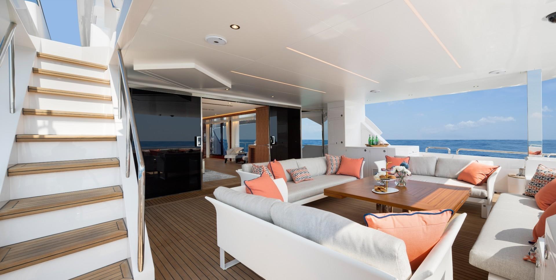 a living room with a staircase and a large window aboard FD92 219 Yacht for Sale