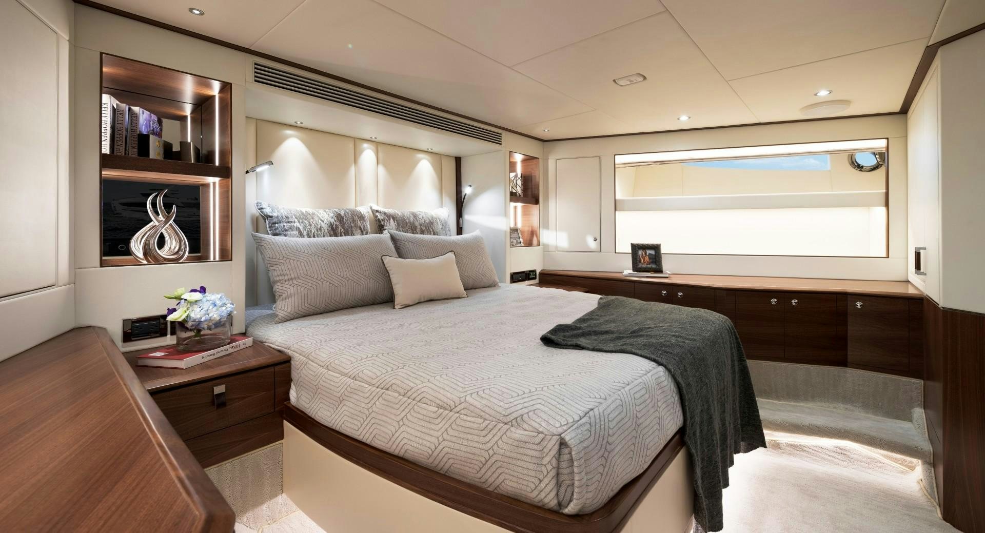 a bed with a black and white pillow and a white wall aboard FD92 219 Yacht for Sale