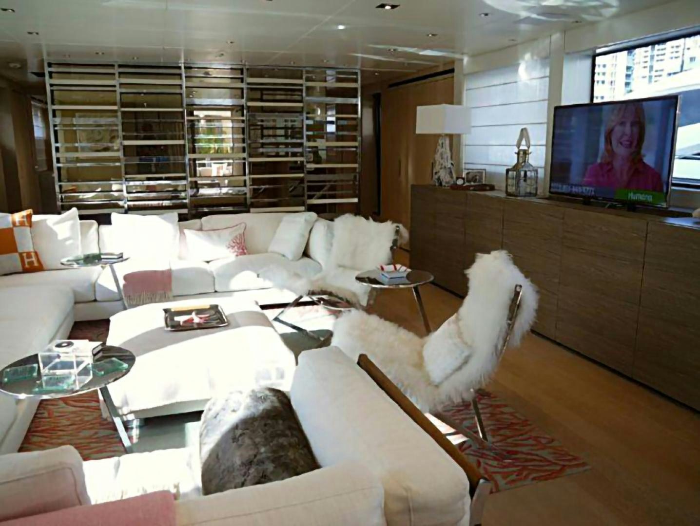 a living room with a large screen aboard No Name Yacht for Sale