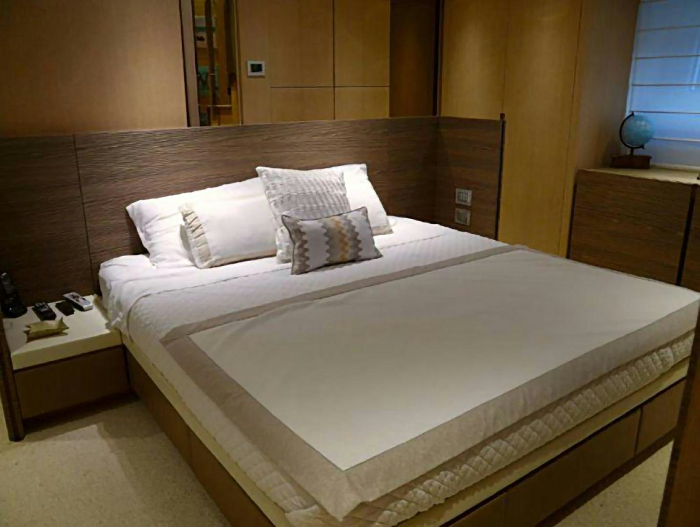a bed with white sheets aboard No Name Yacht for Sale