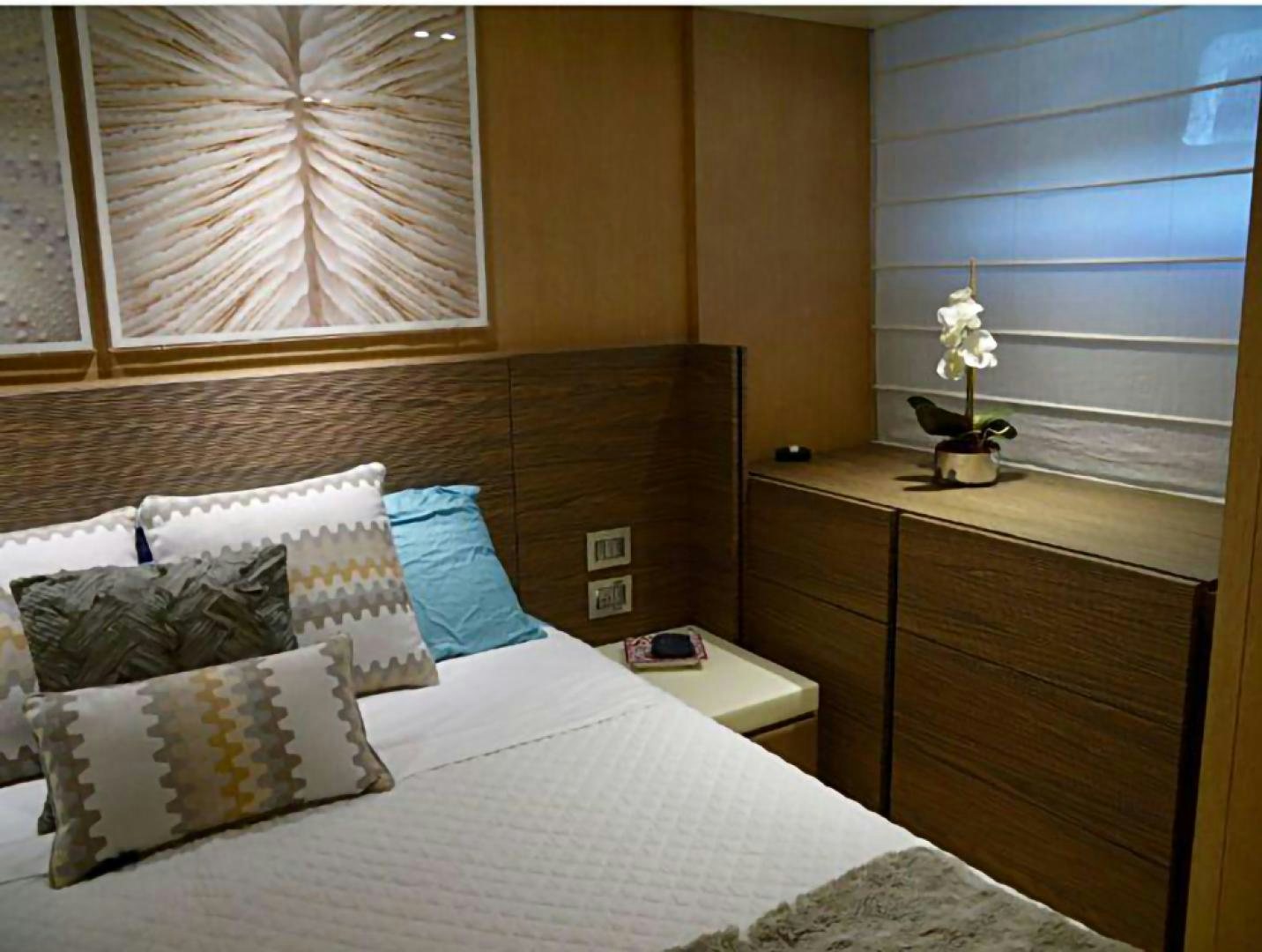 a bed with pillows and a white pillow aboard No Name Yacht for Sale