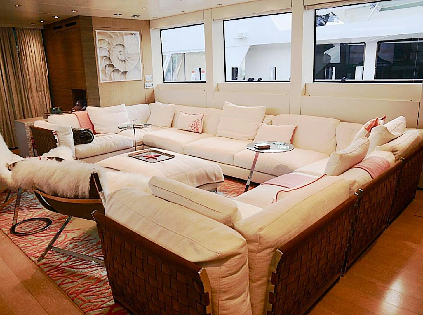 a living room with a couch and a table aboard No Name Yacht for Sale
