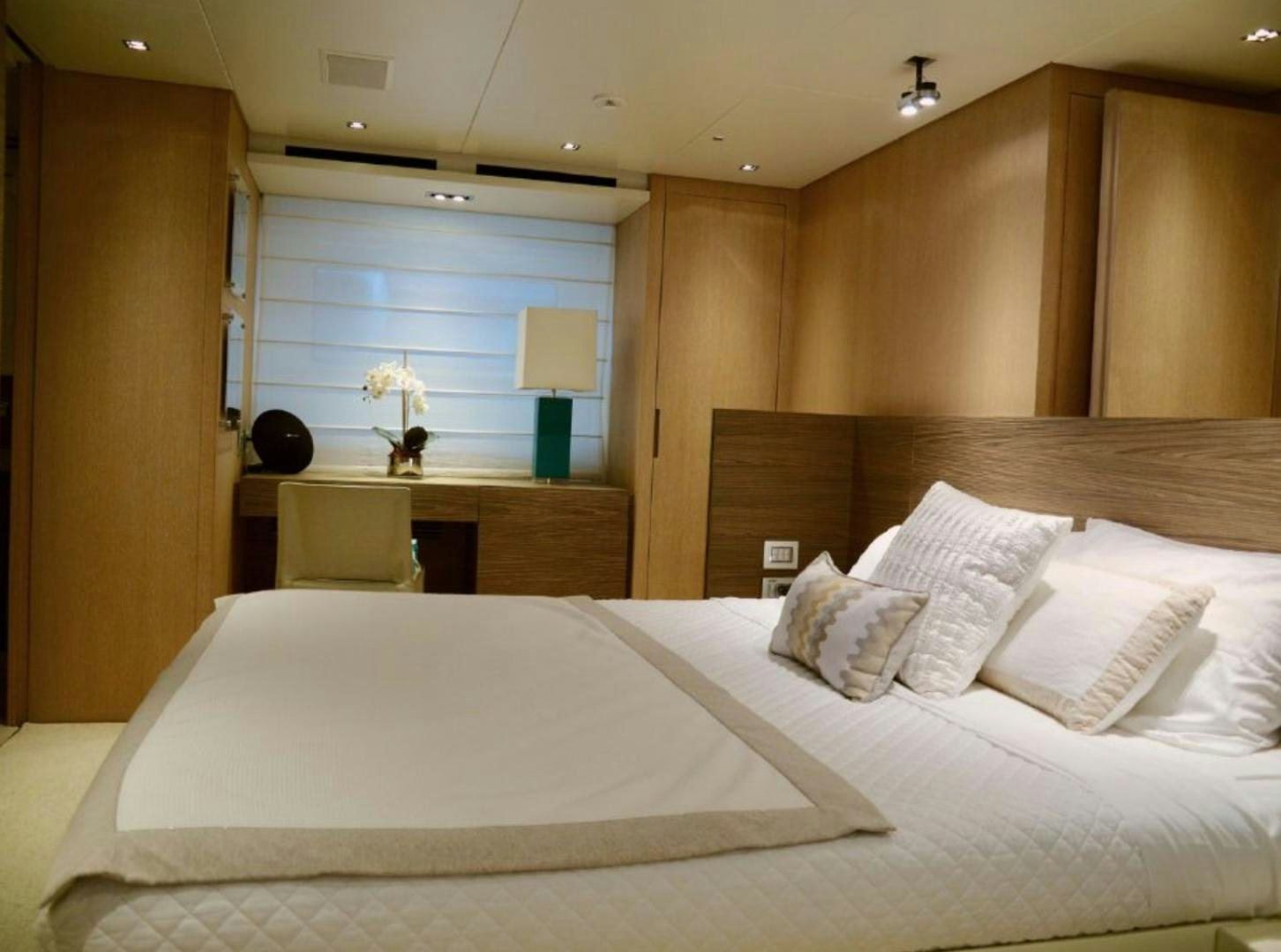 a bed with white sheets and pillows aboard No Name Yacht for Sale