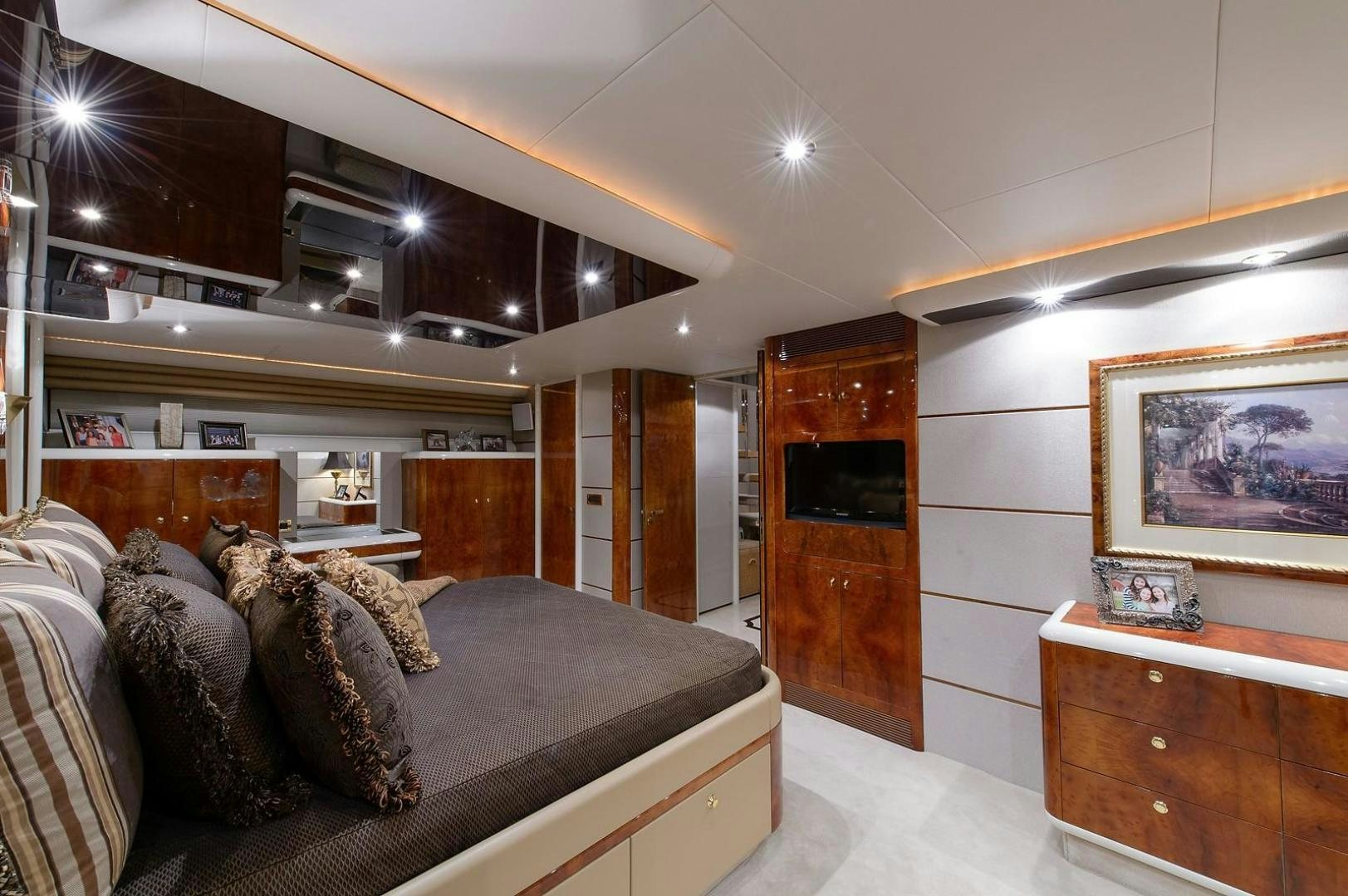 a bedroom with a bed and a dresser aboard BIG WAVE Yacht for Sale
