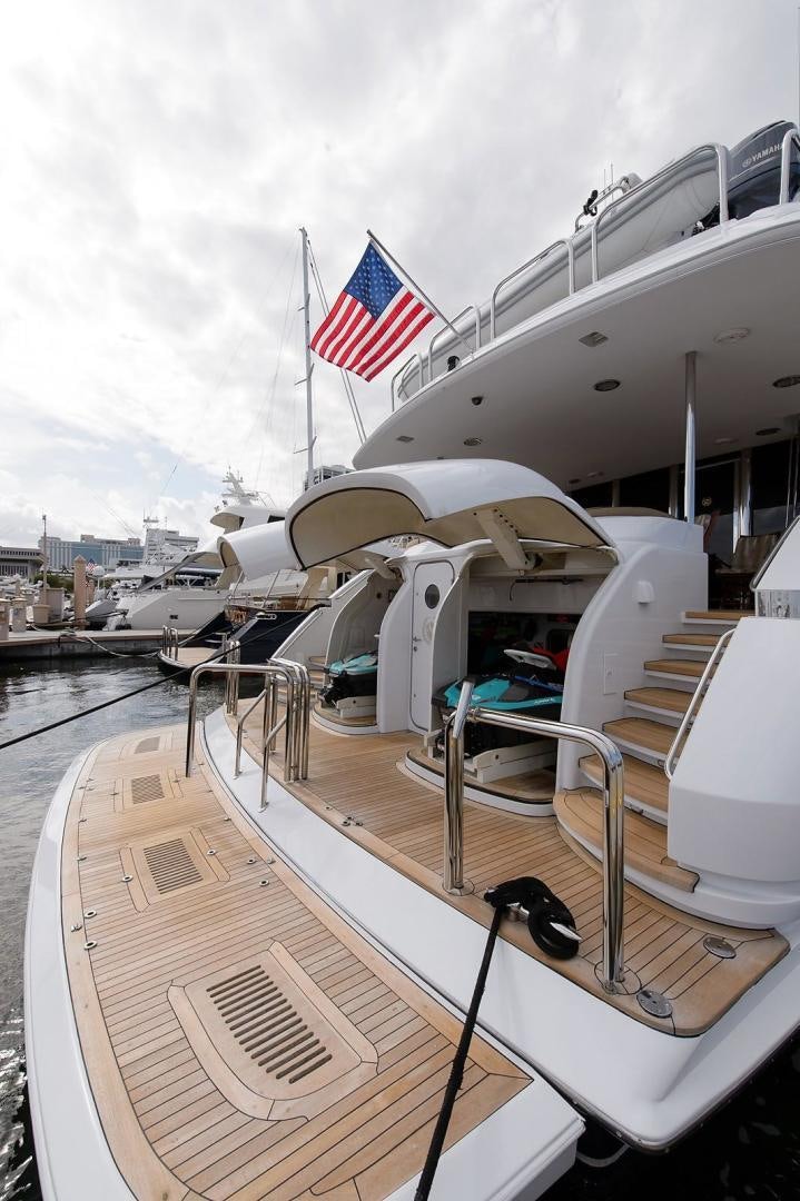 a boat with a flag on the deck aboard BIG WAVE Yacht for Sale