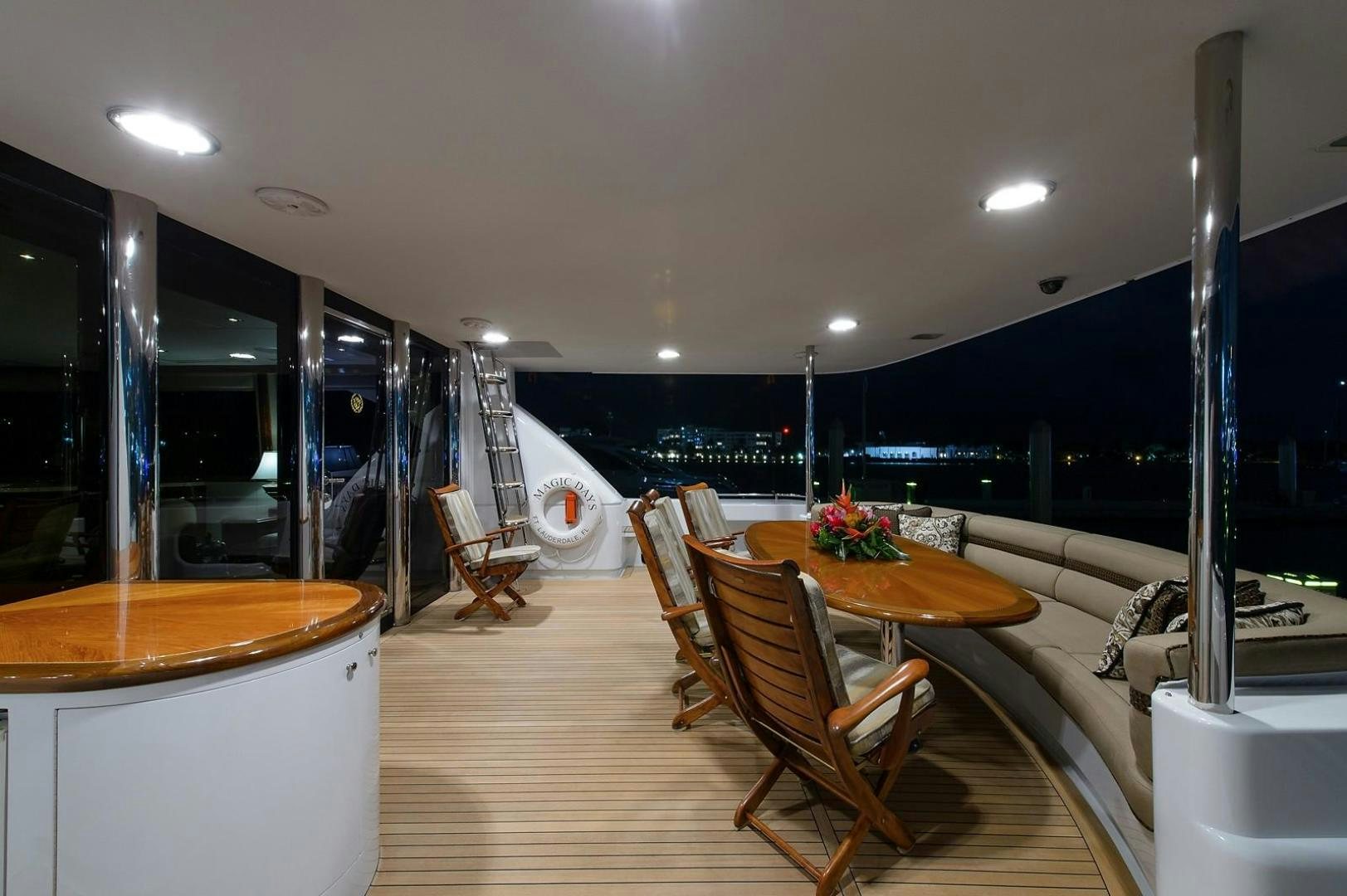 a room with a table and chairs aboard BIG WAVE Yacht for Sale