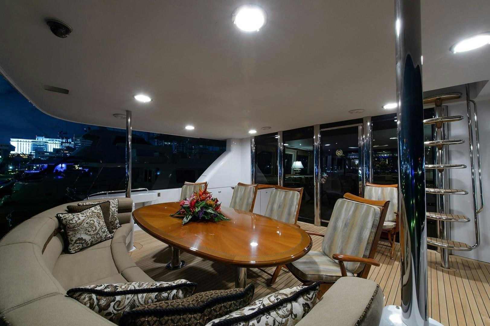 a living room with a table and chairs aboard BIG WAVE Yacht for Sale