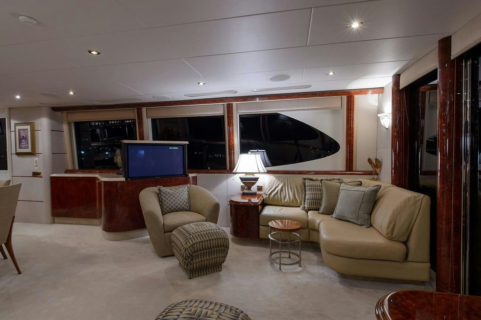 a living room with a couch and a tv aboard BIG WAVE Yacht for Sale