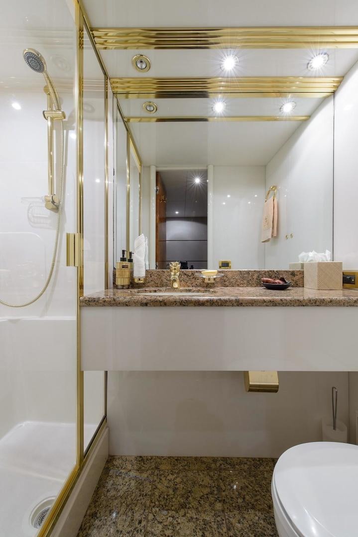 a bathroom with a marble countertop aboard BIG WAVE Yacht for Sale